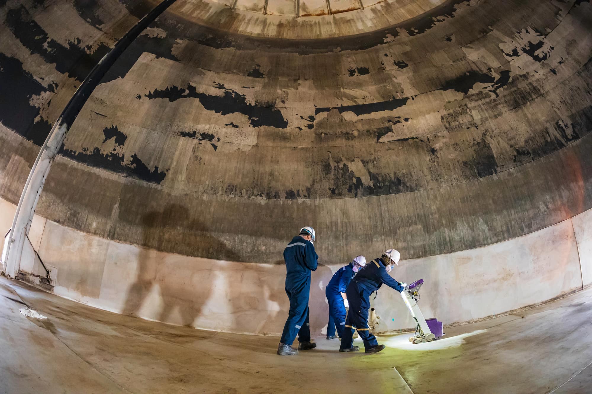Inspectors assessing coating and weld condition inside a storage tank